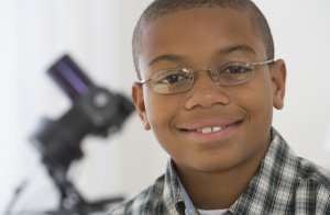 smiling boy with glasses 